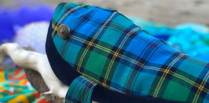 A handmade whale, made from blue, green and yellow Berwickshire tartan sits on the beach at Eyemouth
