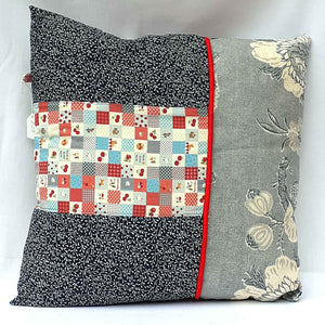 Handmade cushion with patchwork design and bold dark blue and white reverse