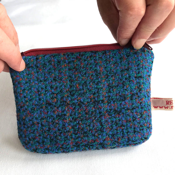 Reverse of blue tweed purse with red zip. 