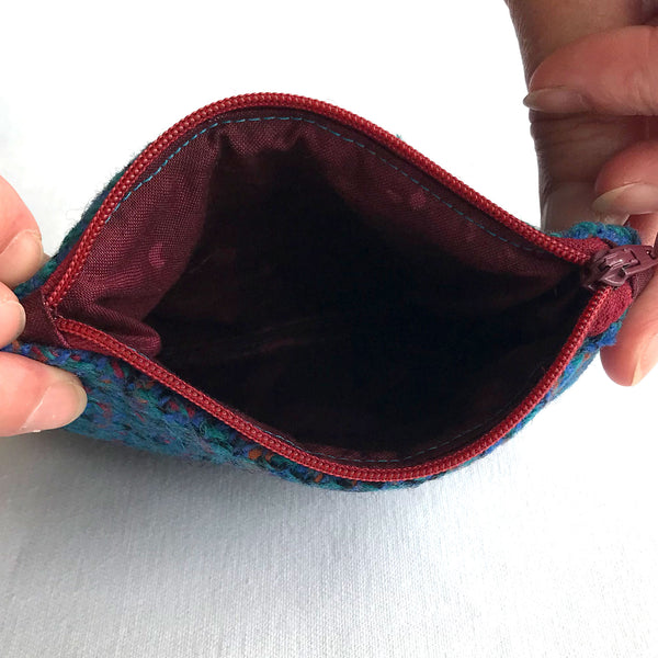 Inside the blue tweed fabric purse, with burgundy fabric and red zip