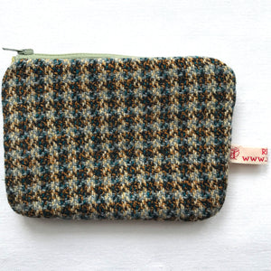 Close up of purse with beige, green and brown tweed