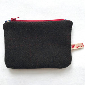Close up of dark brown tweed purse with red zip.. ReTweed label is showing.