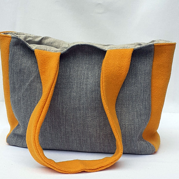 Reverse of bag with mid grey fabric and bright yellow handle