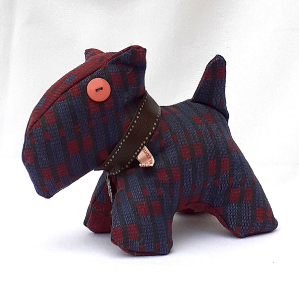 Close up of rear view of scottie dog with maroon and light blue tweed, chunky collar and pink button eye.  ReTweed label on collar.