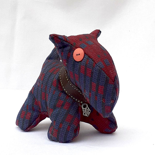 Close up of front view of scottie dog with maroon and light blue tweed, chunky collar and pink button eye. ReTweed label on collar.