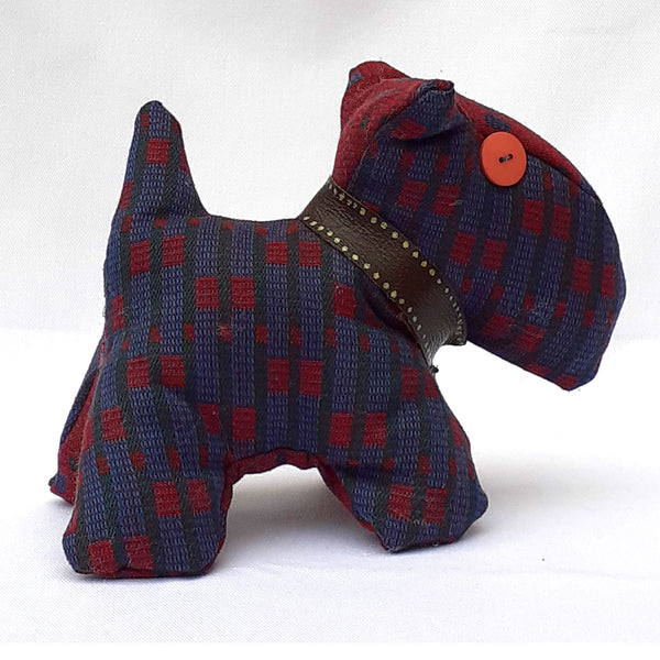 Close up of side view of scottie dog with maroon and light blue tweed, chunky collar and pink button eye. ReTweed label on collar.