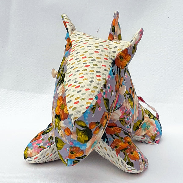 Front view of handmade Scottie Dog -  Floral pattern fabric with a spotty nose and underside. Translucent button eyes. 