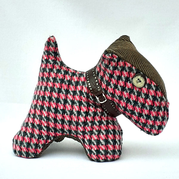 Side view of pink tweed scottie dog with a khaki corduroy nose and brown chunky collar and button nose ReTweed label on collar.