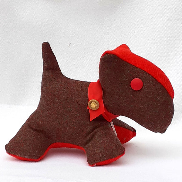 Close up of handmade scottie dog with brown tweed fabric, red stomach, nose, collar and button eye