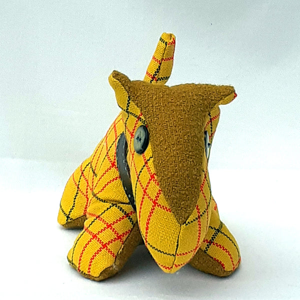 Front view of yellow check tweed scottie dog with brown tweed. Beige nose and stomach, green button nose.